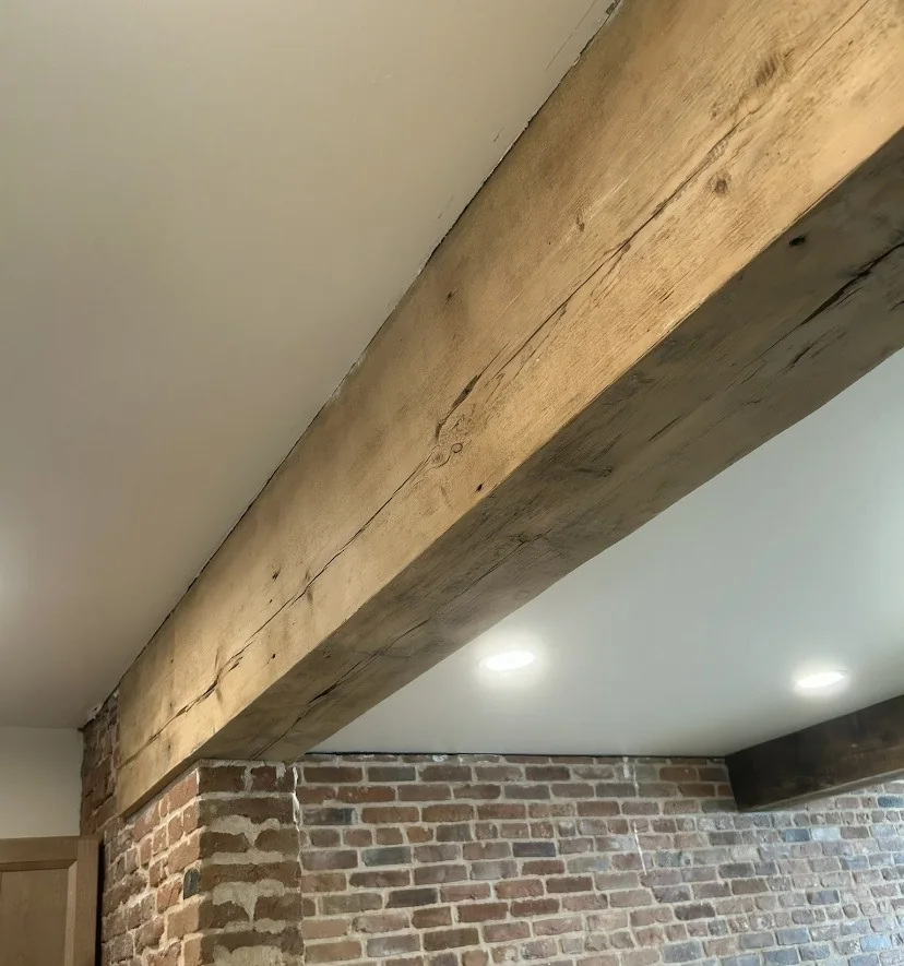 Close view of a wood beam and ceiling finish