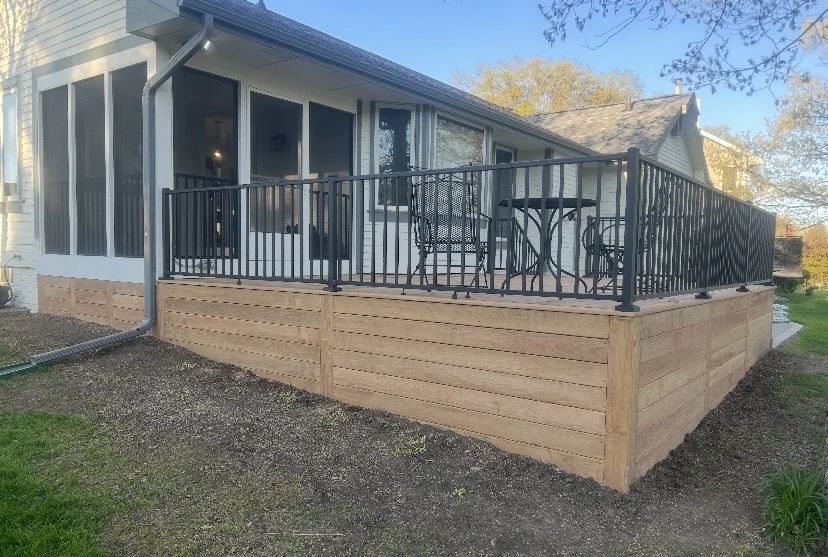 Wood deck with black railings and horizontal skirting