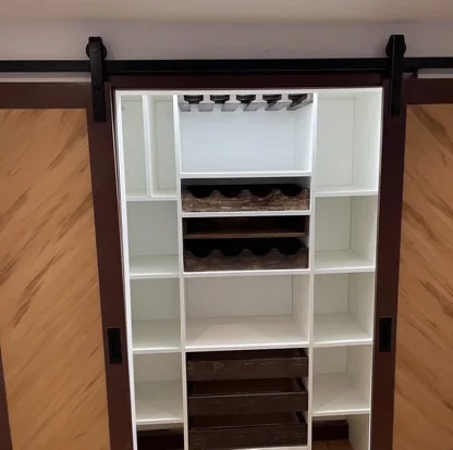 Custom shoe storage behind a sliding barn door