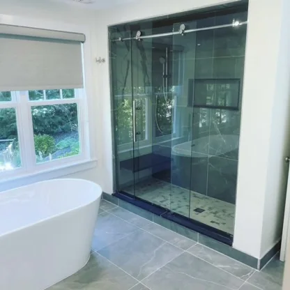 Bathroom with freestanding bathtub and glass-enclosed tiled shower
